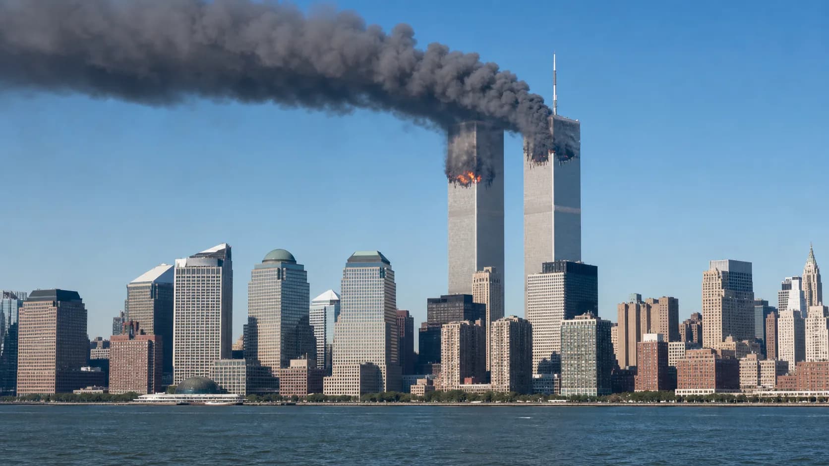 Smoke pours from the twin towers of the World Trade Center above the Manhattan skyline.